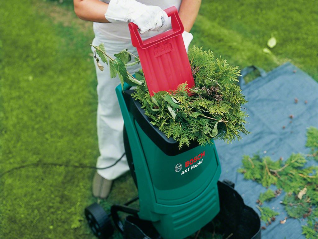 Work of a garden grinder of branches and herbs