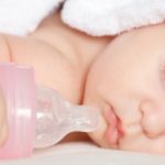 baby sleeps with a bottle